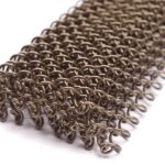 Coil drapery in an antique bronze finish, close view of the interlinked wire rings