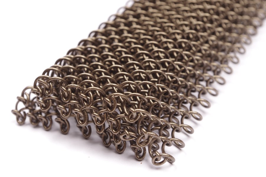 Coil drapery in an antique bronze finish, close view of the interlinked wire rings