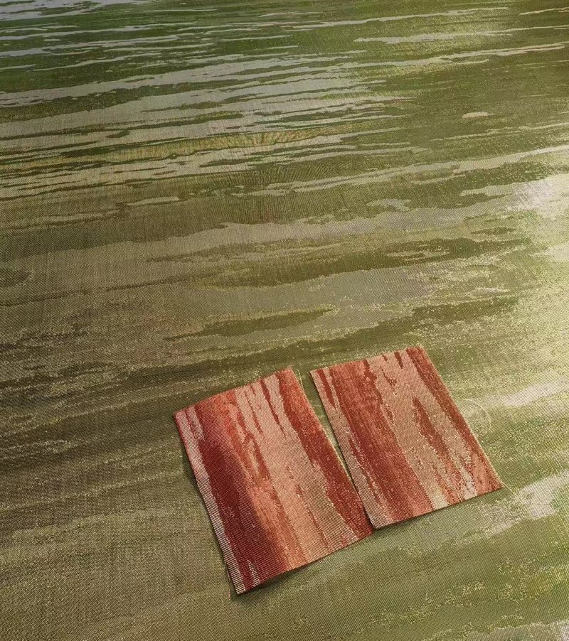 Two copper woven mesh samples laid on a larger laminated mesh panel